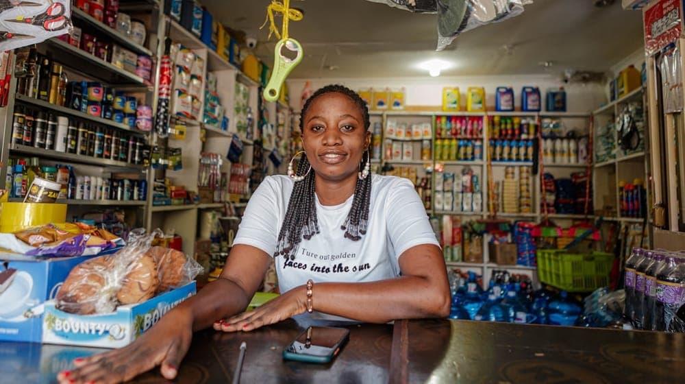 African businesswoman posing inside her small shop