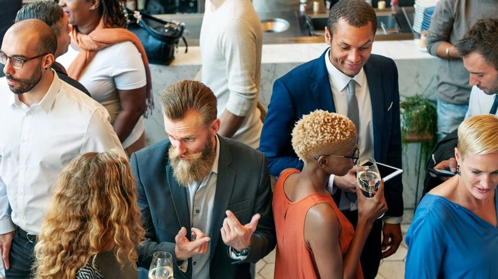 A group of people standing around each other