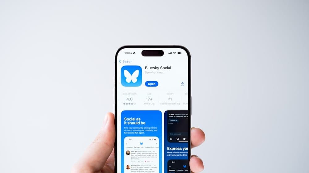 A person holding up a smart phone in their hand